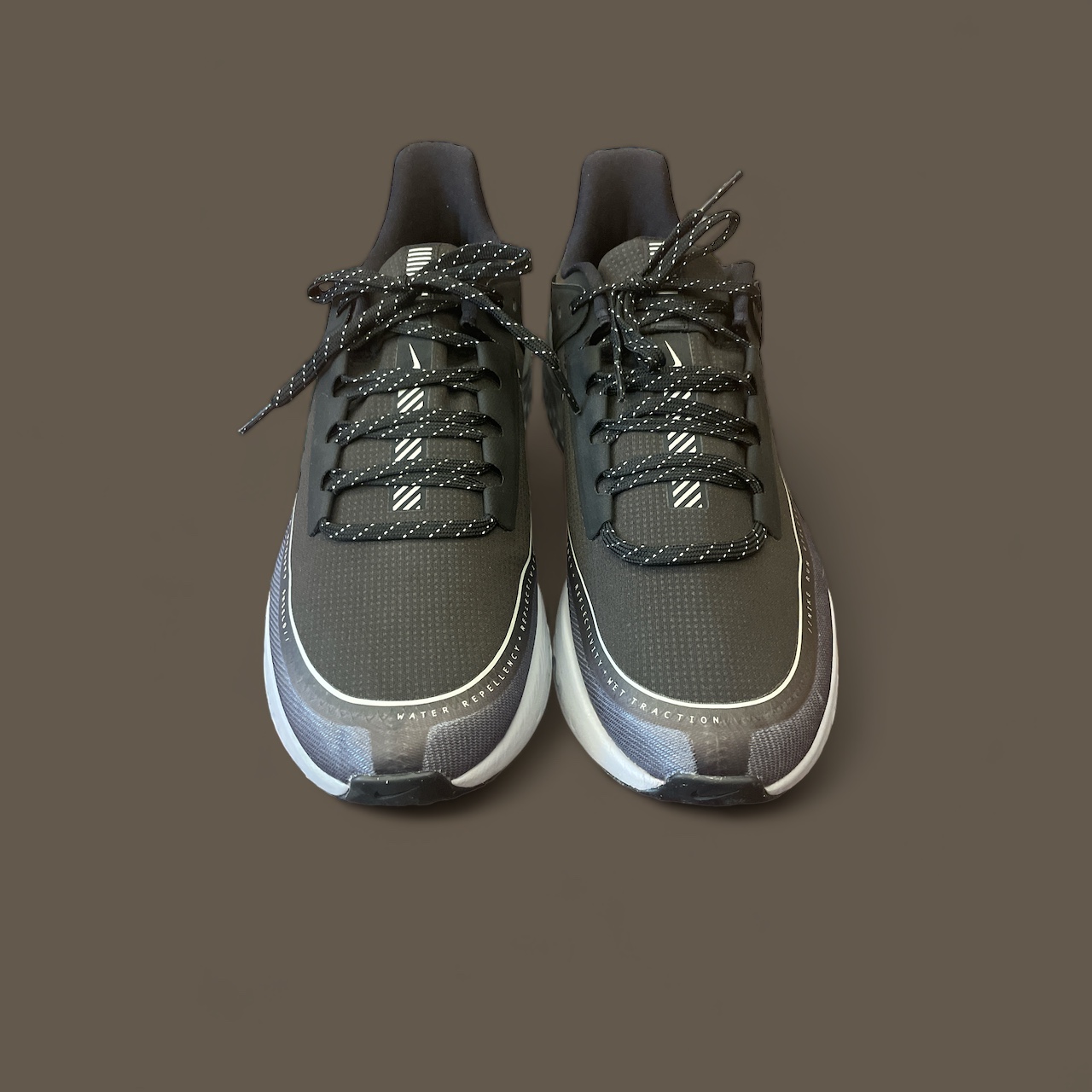 Nike_Mens_Black_React_Running_Shoes_Front_Brown_Background